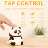 A finger tapping the panda night light to change its light mode