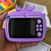 Kids digital camera held in a hand, showing the 2.4 inch screen