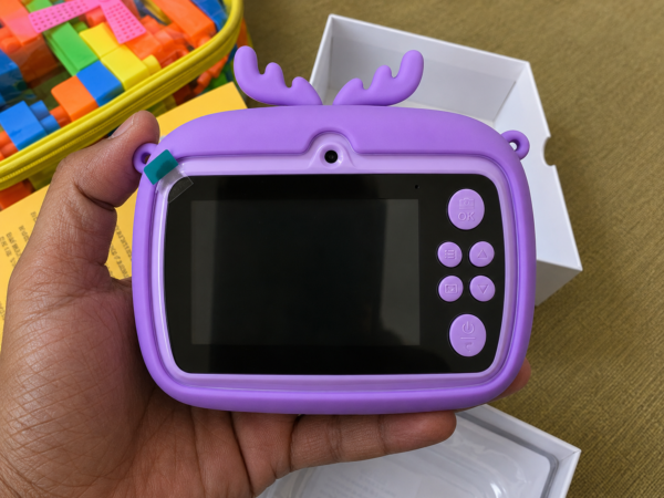 Kids digital camera held in a hand, showing the 2.4 inch screen