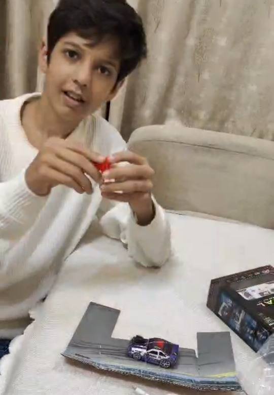 Mikail holding a remote-control car from the Tukoy RC car set