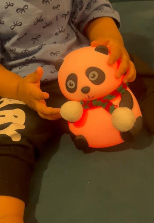 The Tukoy colour-changing panda toy glowing in a child’s hands
