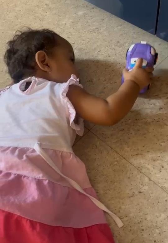 A toddler playing on the floor with the Tukoy transformer car
