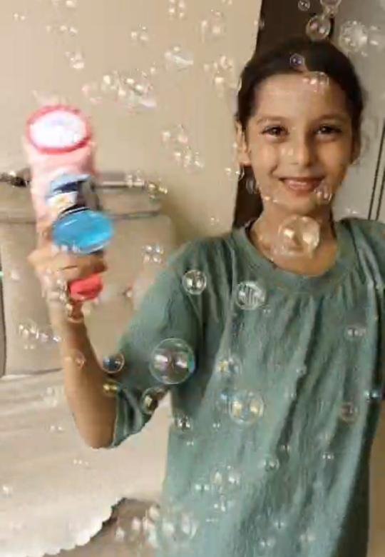 Urwa surrounded by bubbles from the Tukoy pink bubble gun