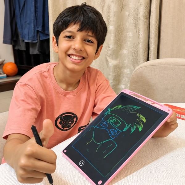 Mikail drawing on a Tukoy LED writing pad at home